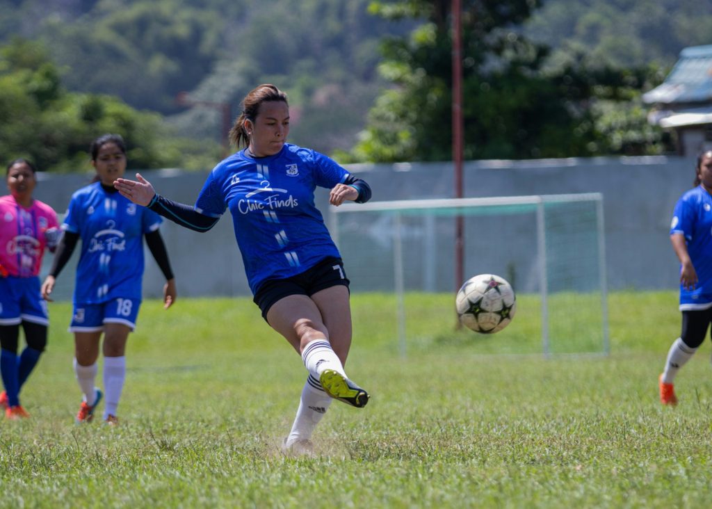 A group of girls playing a game of soccer